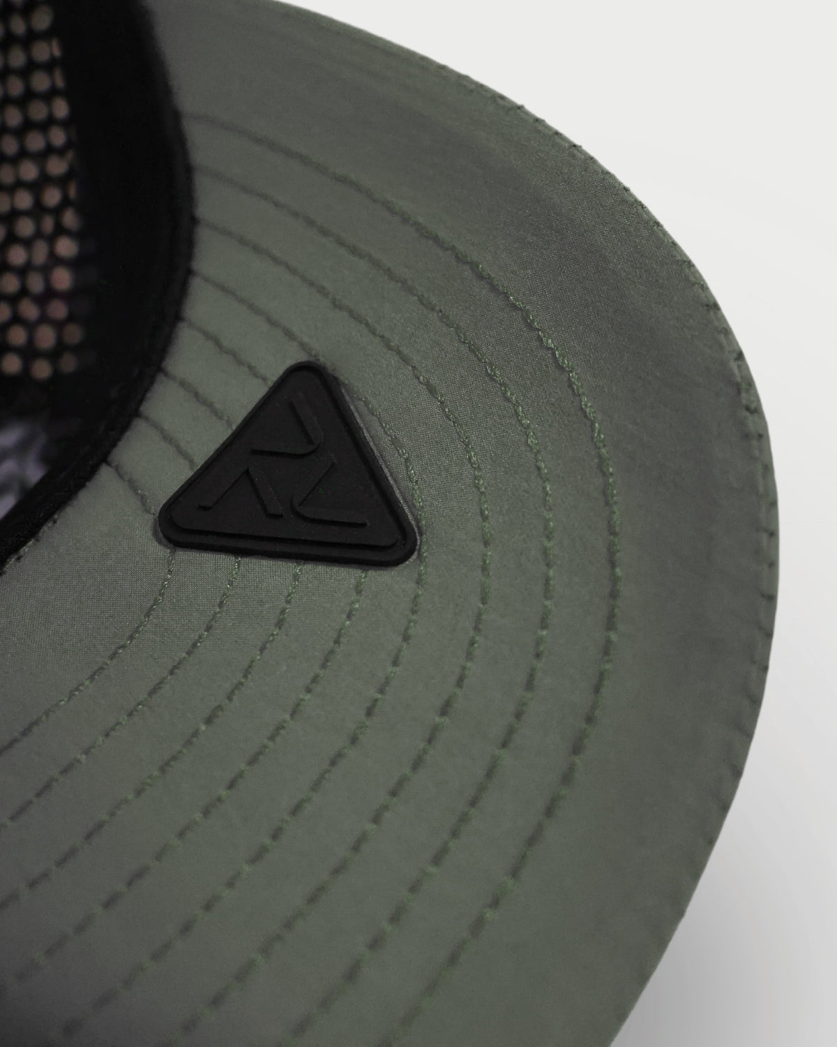 Close-up of the green Vohl Cap underside brim with stitched detailing and black Vohl logo patch - SKU AC-CP-400