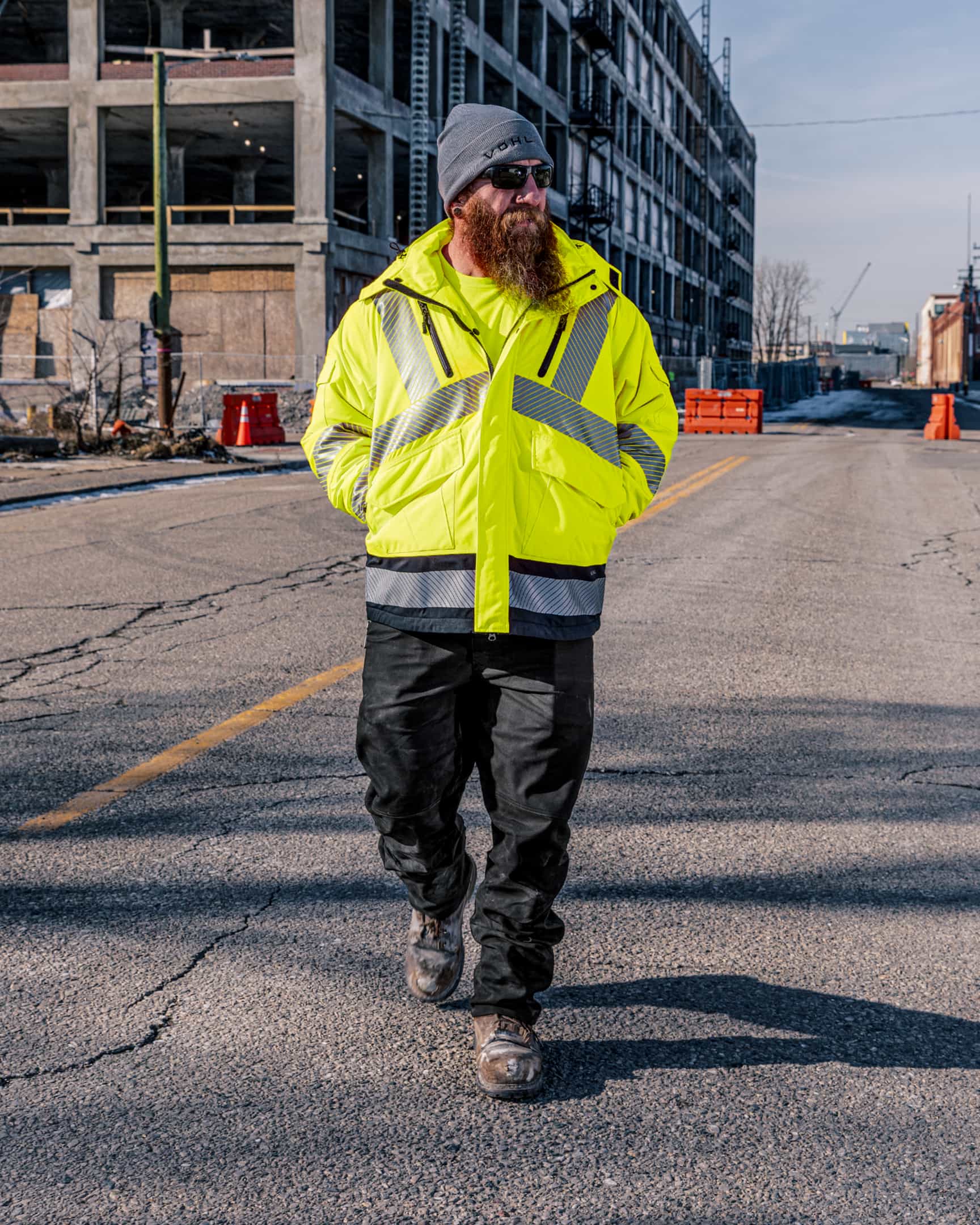 Men’s hi-vis yellow insulated waterproof jacket with reflective tape, worn on a construction site – SKU HV-IJ-105 | color:safety-yellow