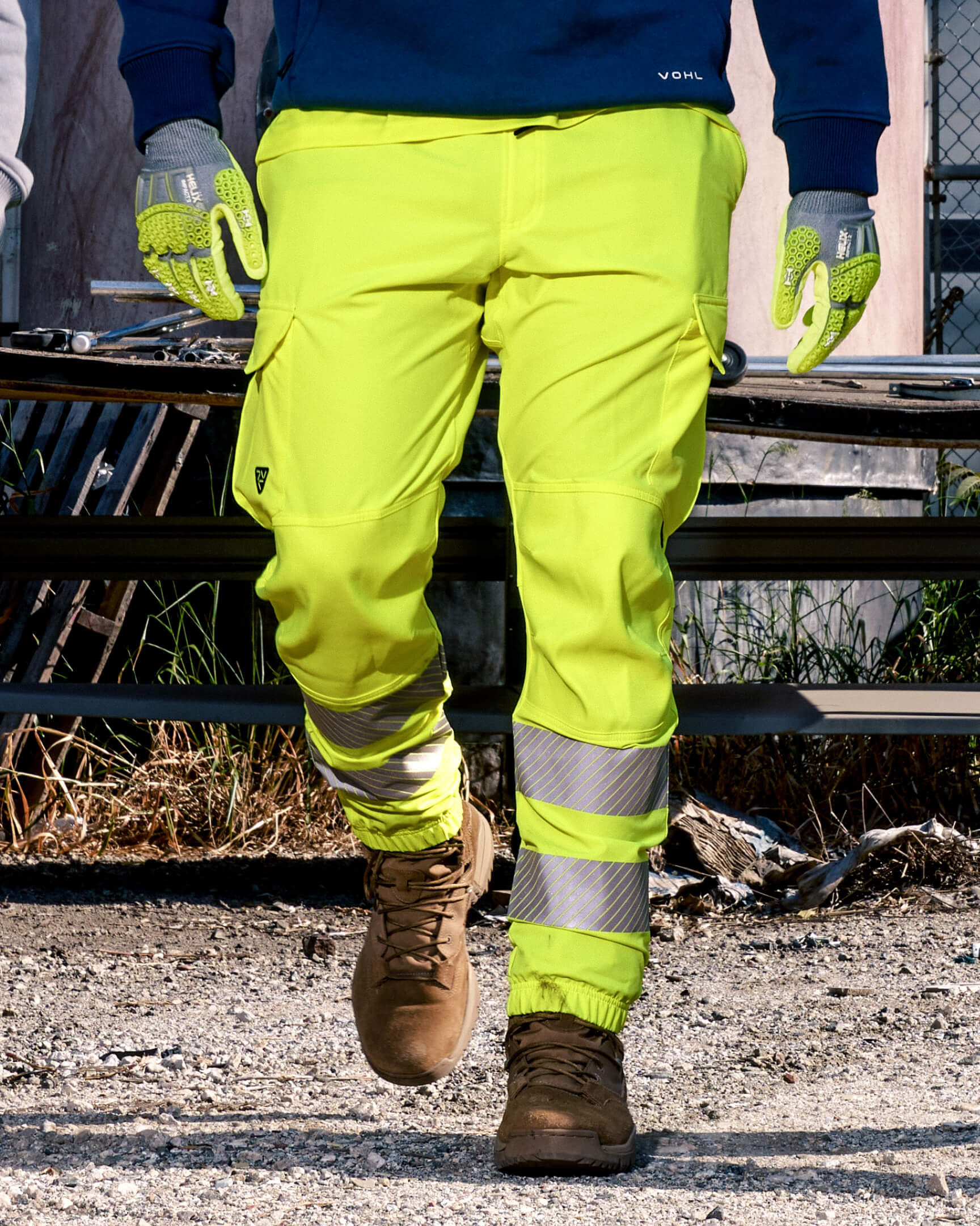 VOHL Hi Vis Jogger Pant – Safety Yellow shown in a close-up kneeling position, highlighting the stretch knee panels, cargo pocket and ergonomic fit | color:safety-yellow