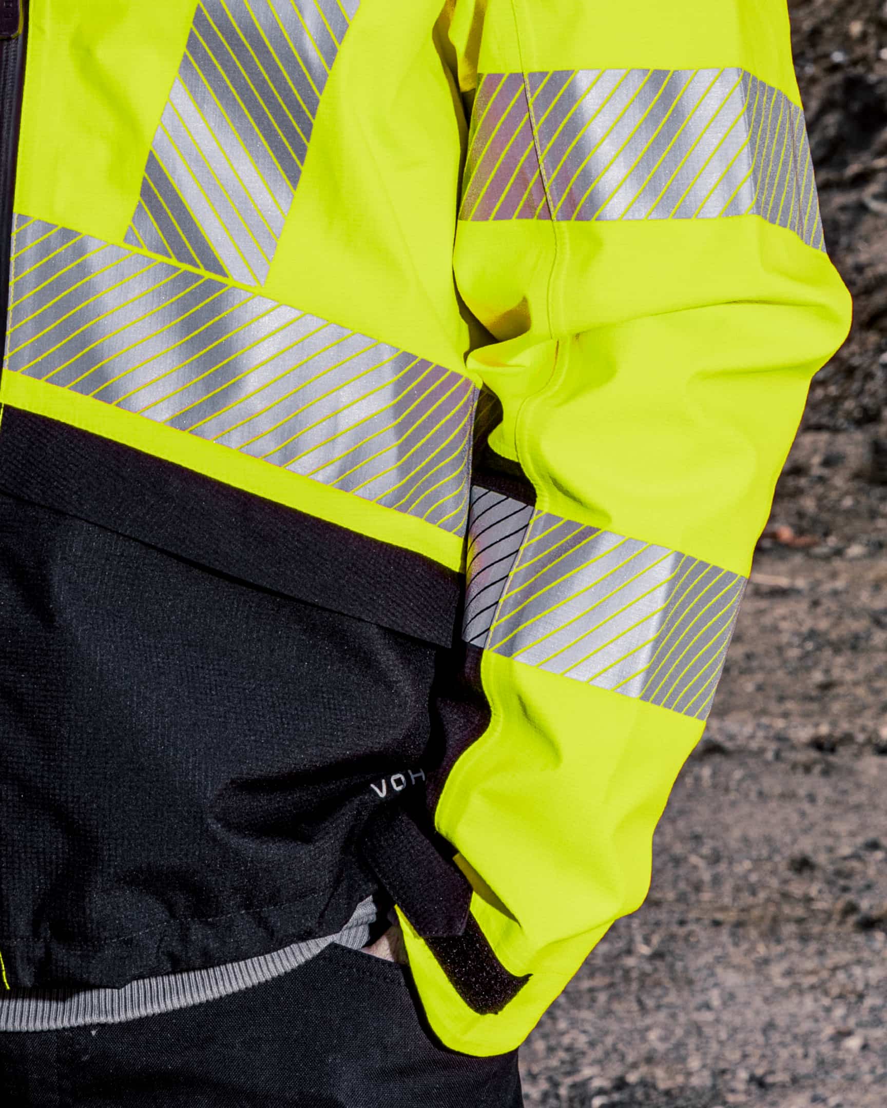 Close-up of hi-vis yellow waterproof shell jacket with reflective tape and sleeve detail – SKU HV-SJ-105 | color:safety-yellow