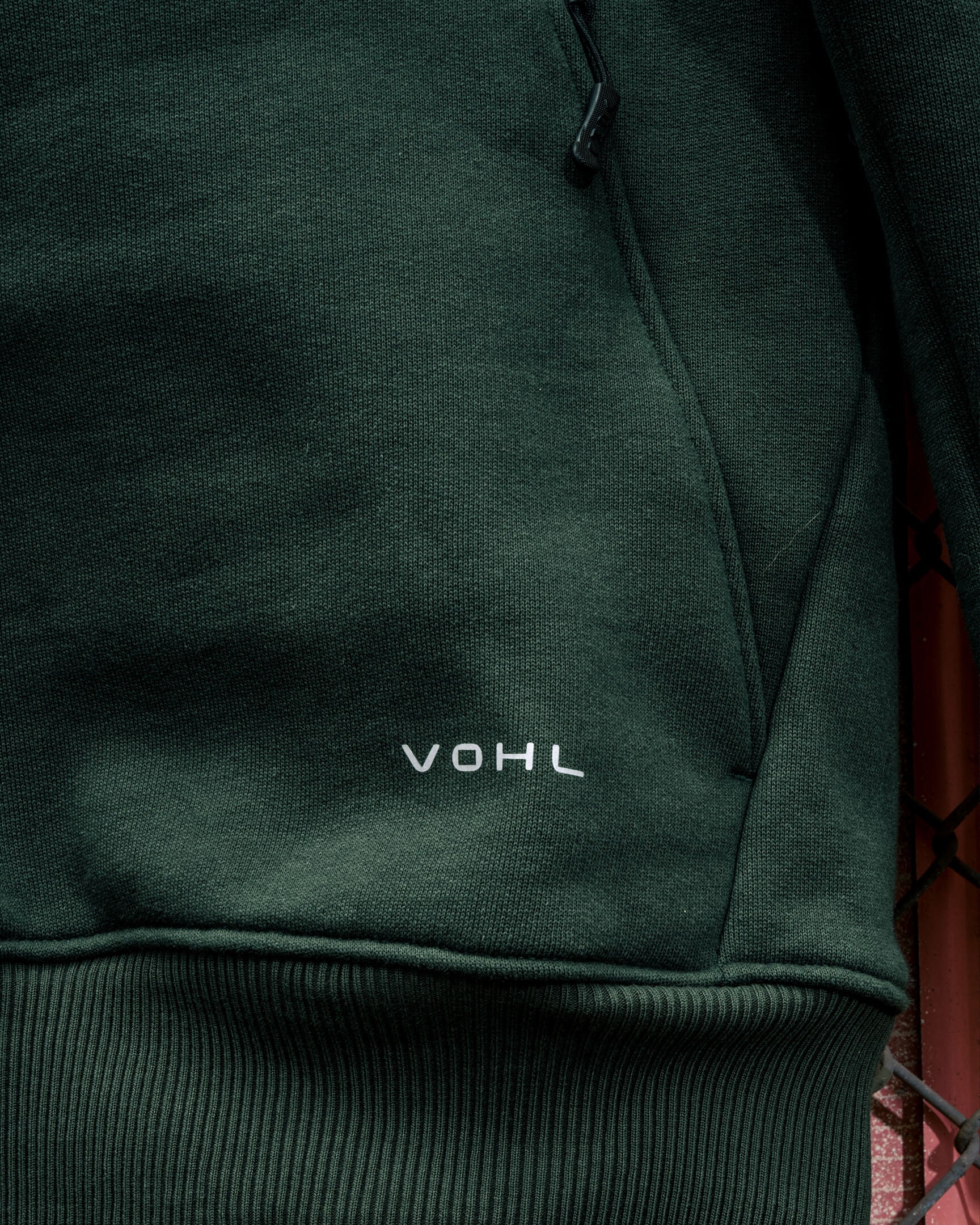 Close-up of the VOHL Heavyweight Fleece Hoody – Deep Forest Green featuring the front kangaroo pocket and embroidered logo | color:deep-forest-green