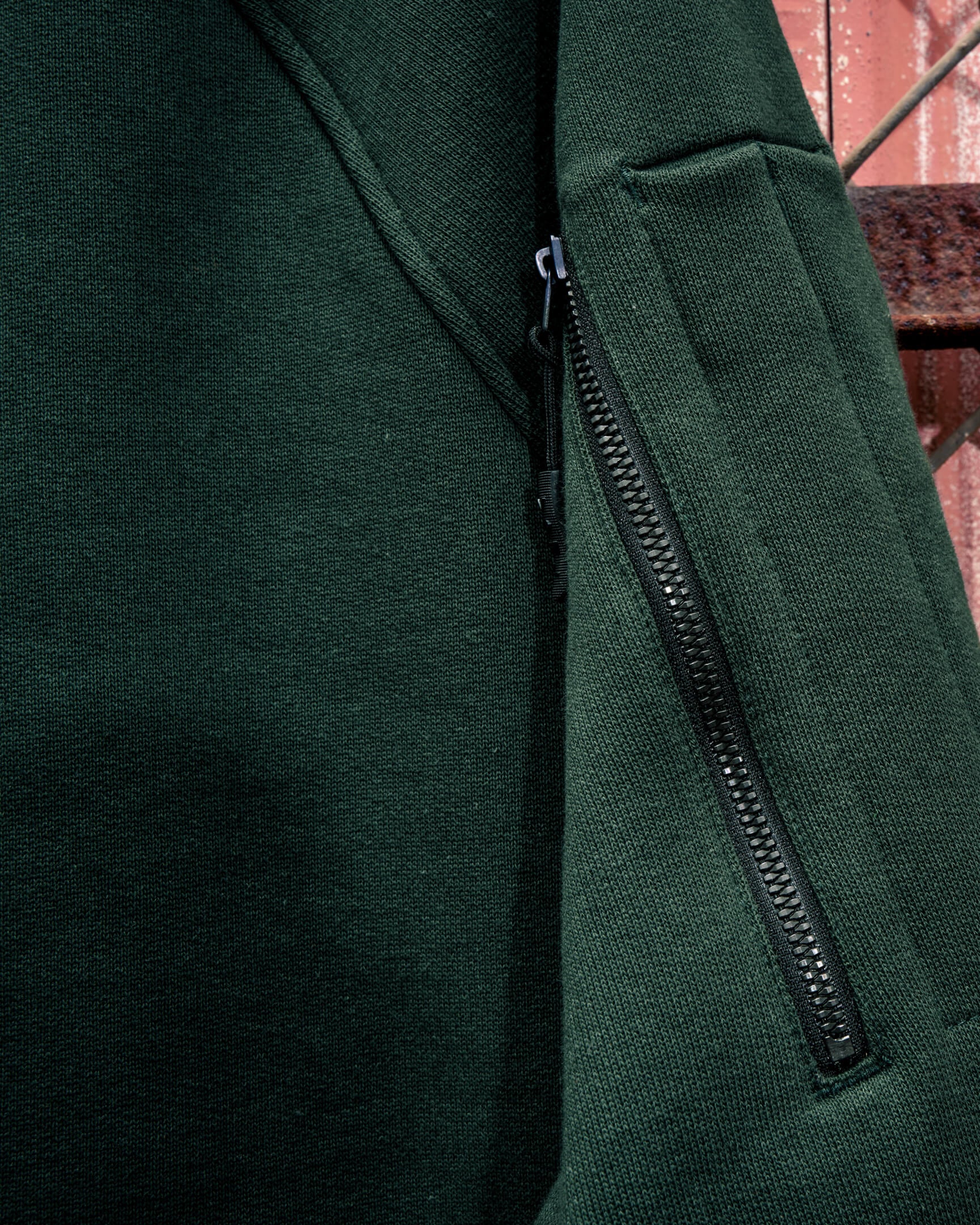 Close-up of the VOHL Heavyweight Fleece Hoody – Deep Forest Green showing the concealed sleeve zip pocket | color:deep-forest-green