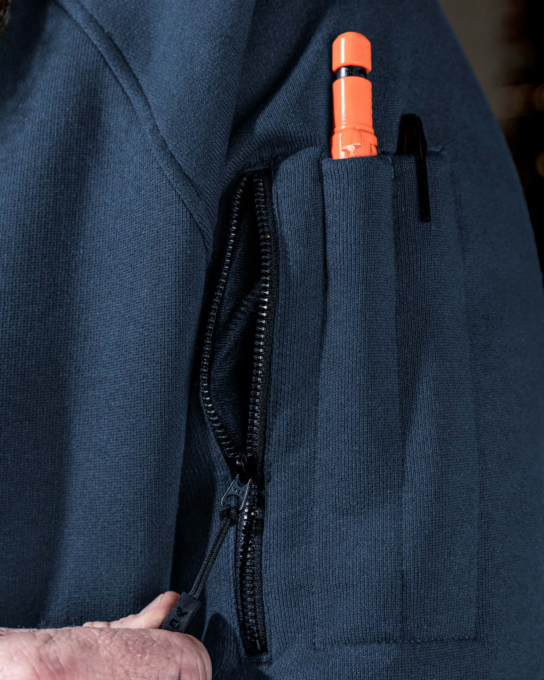 Close-up of blue heavyweight fleece hoody sleeve pocket with zipper and pen slot – SKU WW-PO-600 | color:detroit-blue