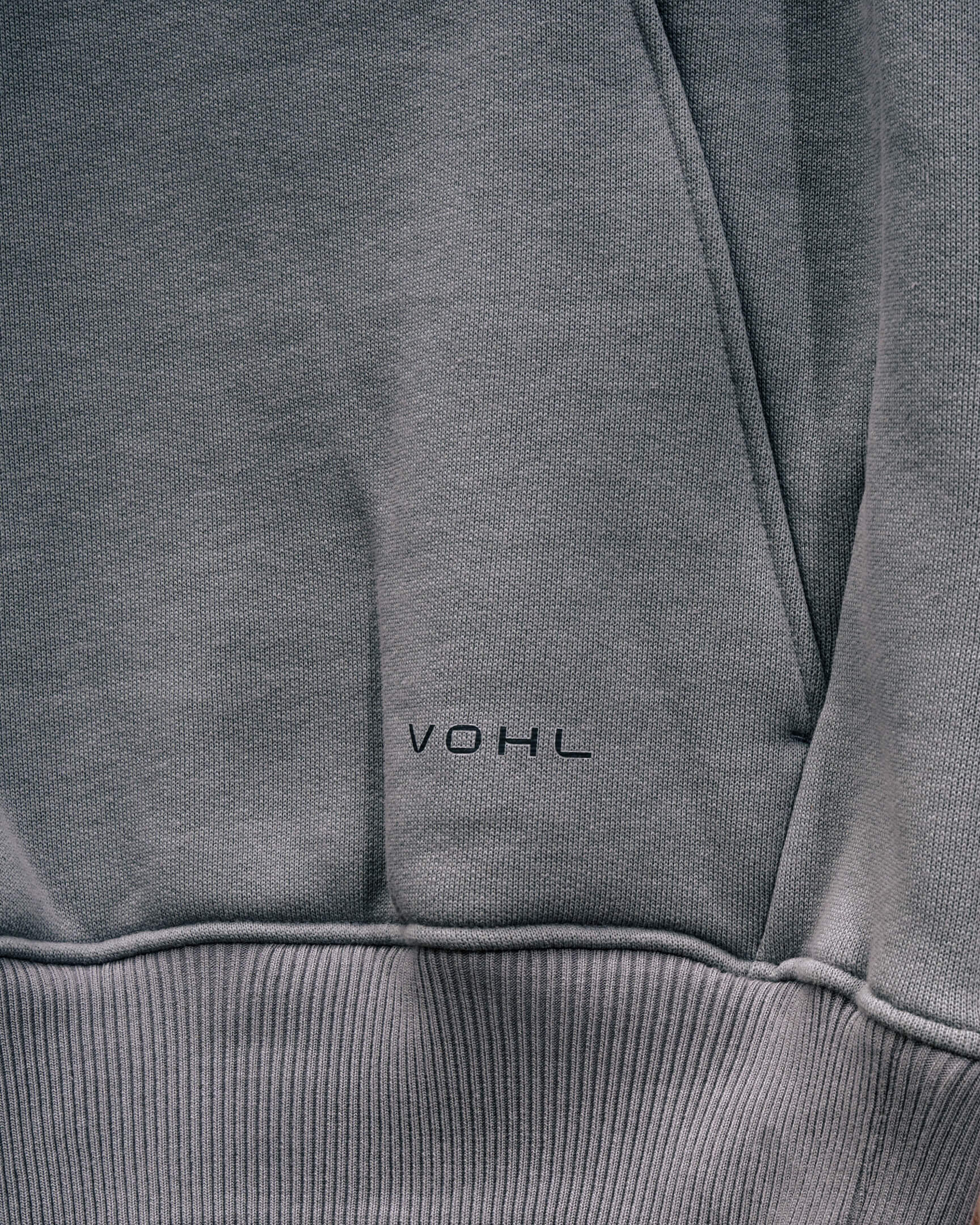 VOHL Heavyweight Fleece Hoody – Pewter showing the front pocket and logo in a detailed product close-up | color:pewter
