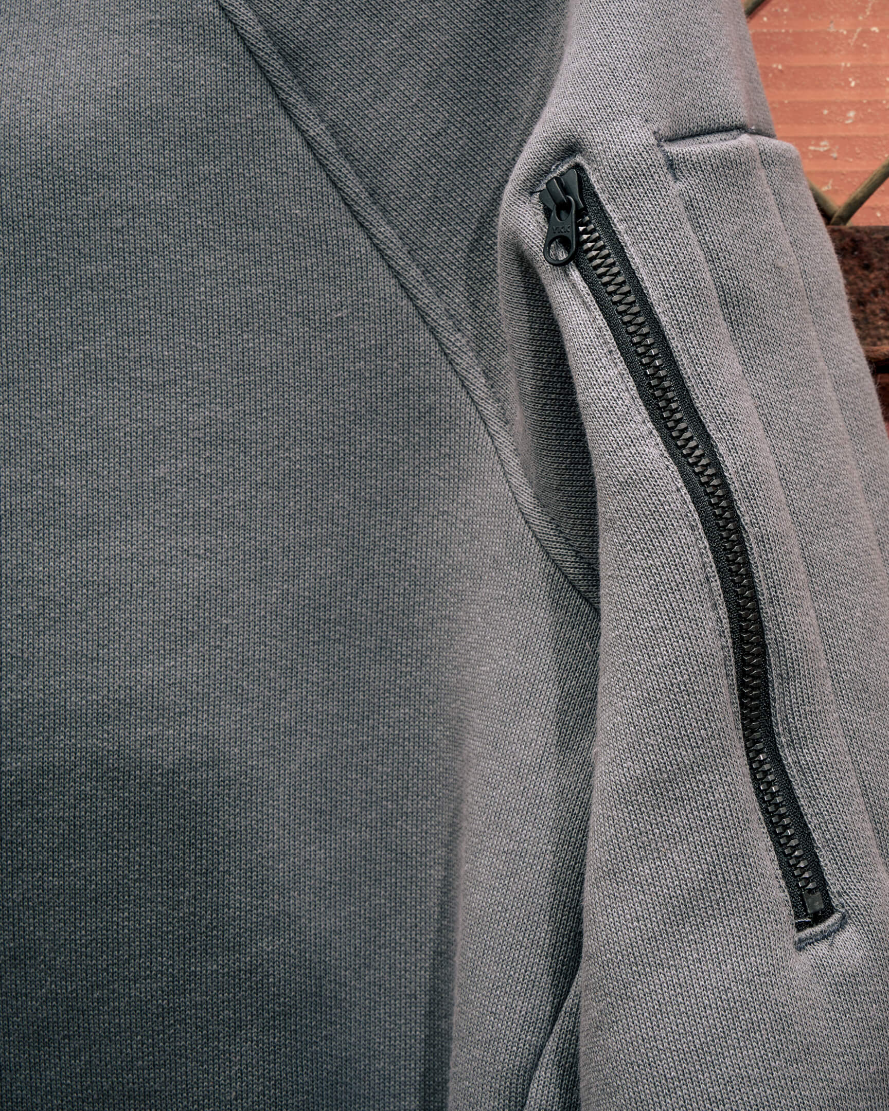 VOHL Heavyweight Fleece Hoody – Pewter highlighting the concealed sleeve zip pocket and clean technical finish | color:pewter