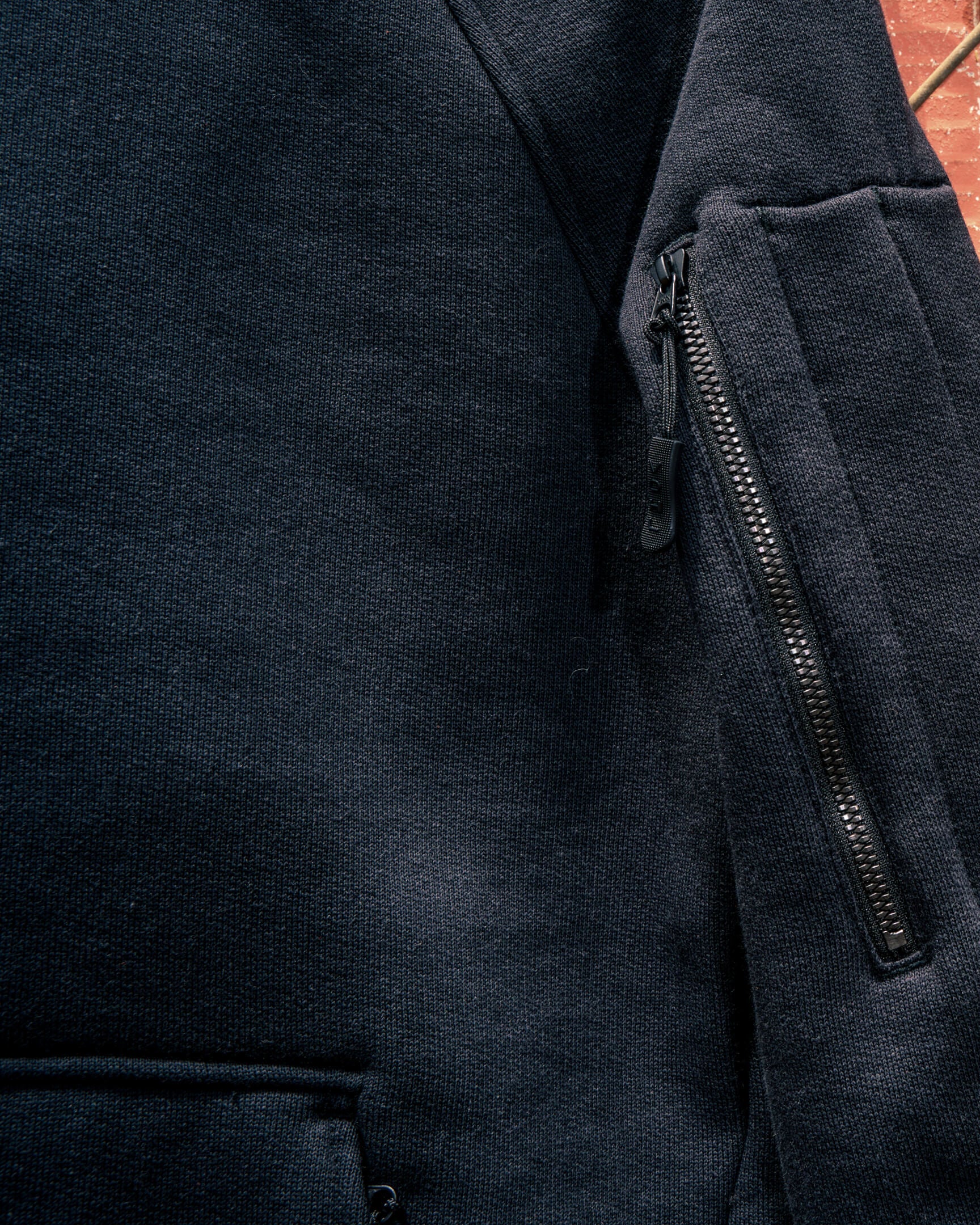 VOHL Heavyweight Fleece Hoody – Black highlighting the concealed sleeve zip pocket and durable construction | color:black