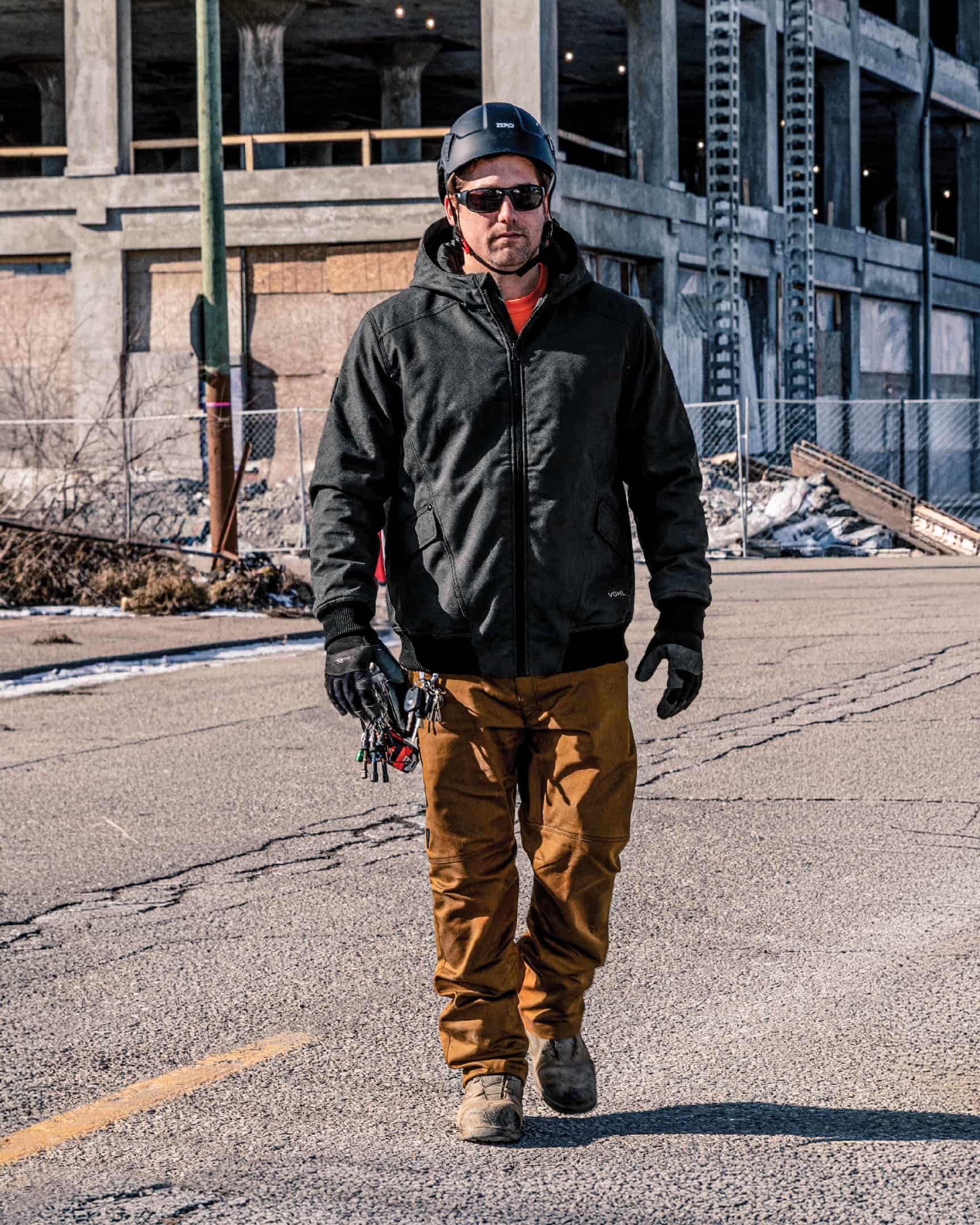Men’s black quilted lined work jacket worn on construction site with safety helmet – SKU WW-UJ-900 | color:black